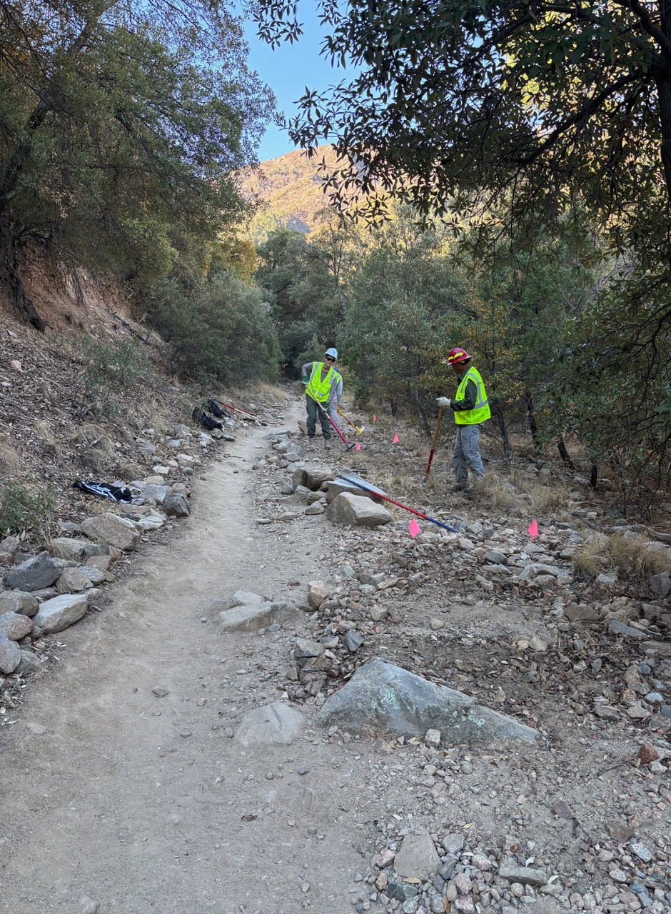 Fig 1. Stacey Barnes and David Linn work in the newly marked outsloped section while leaving the existing trail open to hikers.