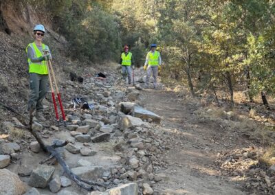 Fig 2. Stacey Barnes, David Linn, and Tom Bailey close off the old trail and apply finishing touches to the new trail track.