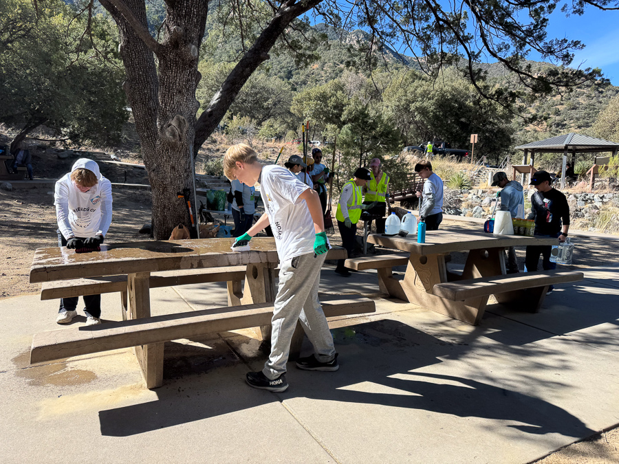 Volunteers cleaning a picnic table